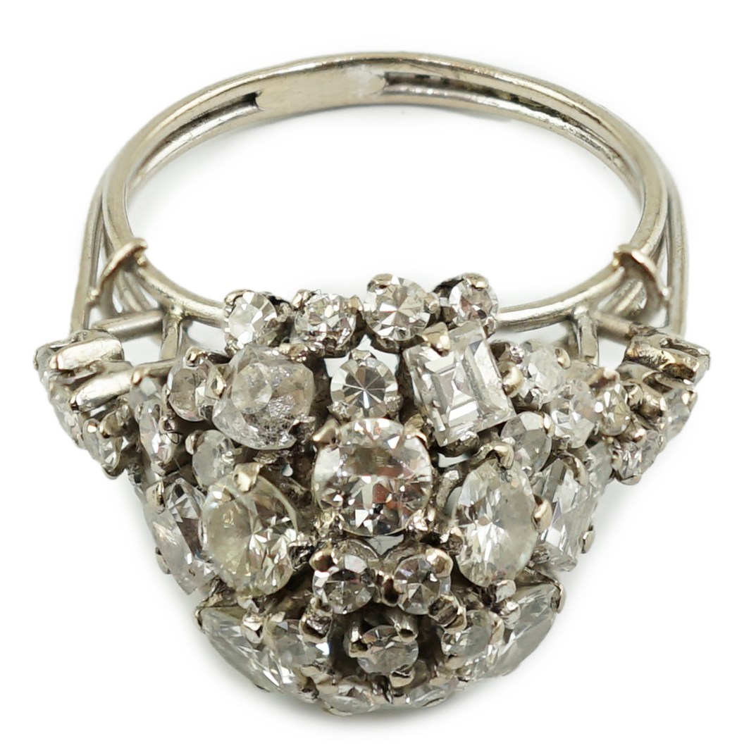 A mid 20th century platinum? and diamond cluster set dome shaped dress ring, with diamond set shoulders